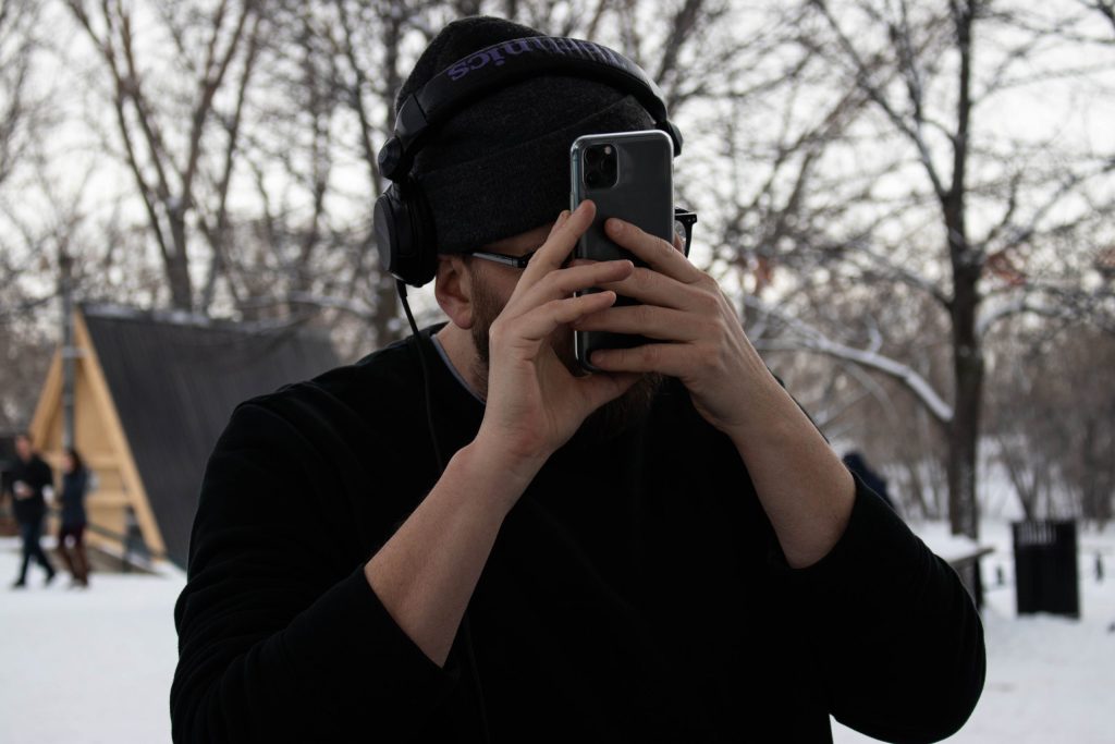 Tyler holding his phone right in front of his face to read it.