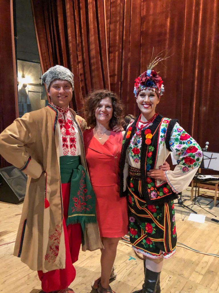 Alexander, and Orycia in costume smiling at the camera with their arms around Orycia's mother.
