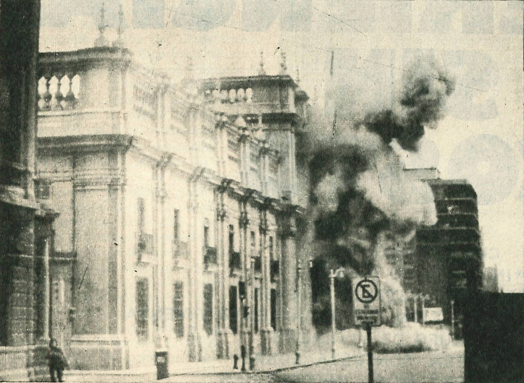 An archive newspaper photo of smoke billowing out of a building.