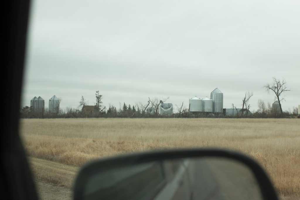 View of a Prairie farm outside a truck window