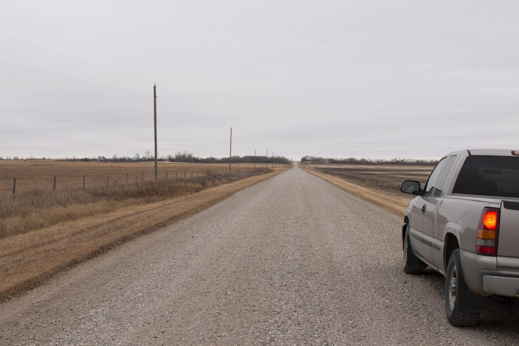 Pickup truck parked on the side of a rural road
