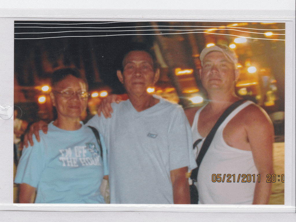 Two Filipino parents with their adopted Filipino-Canadian son on a beach in Boracay. A doodle animation of lines waves behind them.