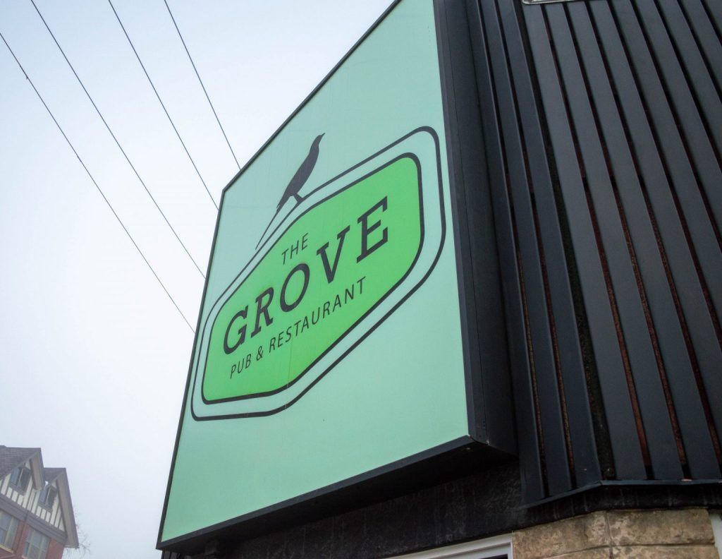 The big green sign of The Grove Pub & Restaurant