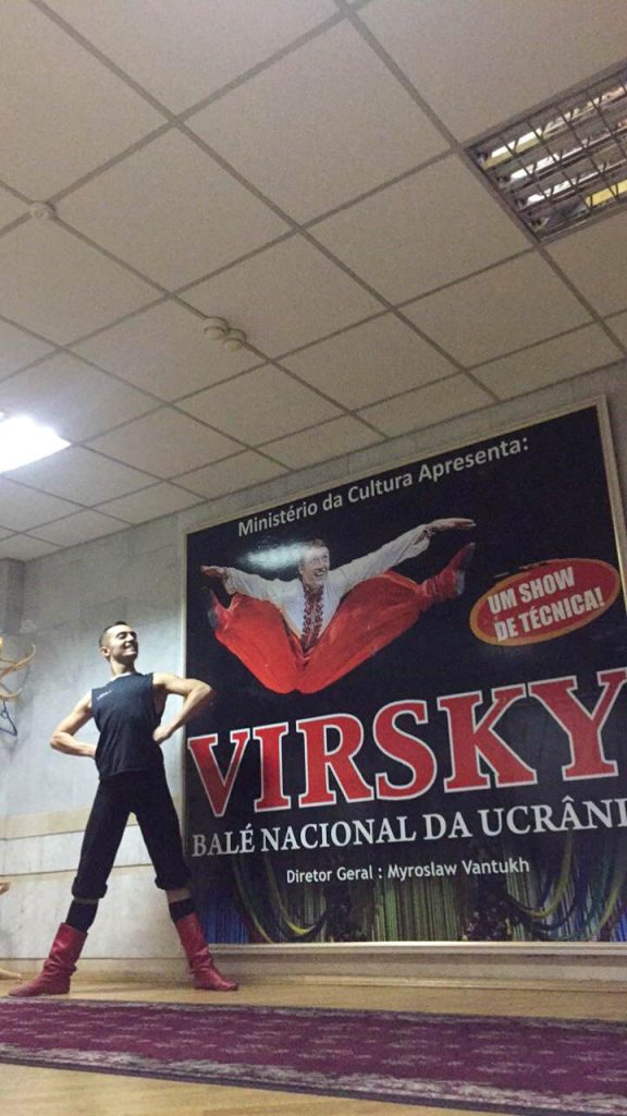 Markian posing with his hands on his hips and feet shoulder width apart in Virsky Studios.