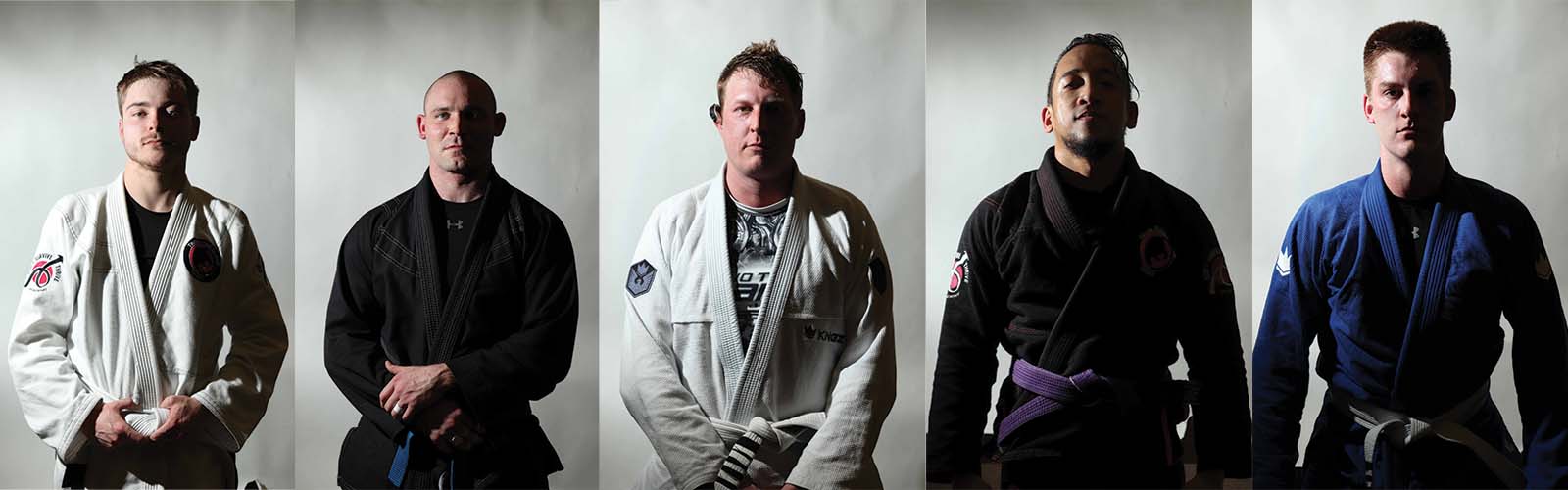 Jiu-jitsu fighters look into the camera in a row.