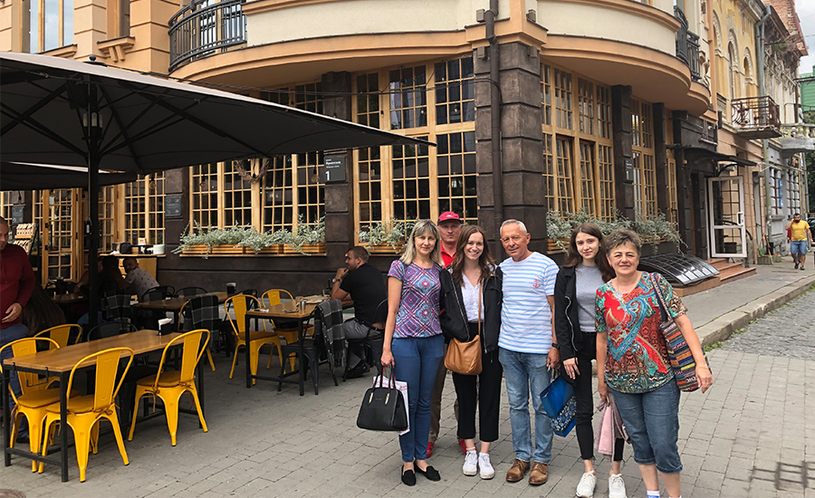 Liliya poses with her aunts, uncles and cousin on a street in Ukraine.