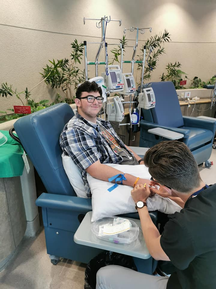 Ross sitting in a chair at the hospital receiving one of his last chemotherapy treatments. 