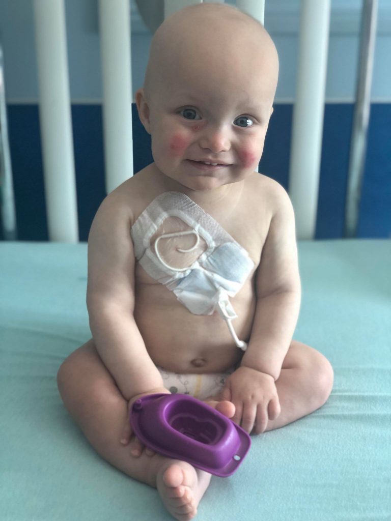 Malcolm sitting in the hospital, his central line is clearly visible on his chest.