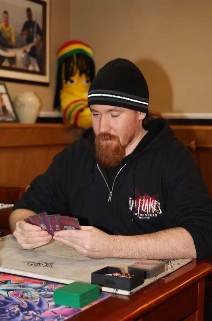 2026-ADEOCAMPO-Photo of Jesse Forbes looking down looking at his cards on hand.