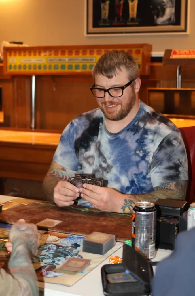 2026-ADEOCAMPO-Photo of Ryan Wiebe holding cards.