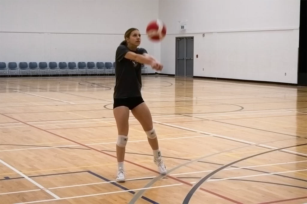 Avery passing a volleyball.