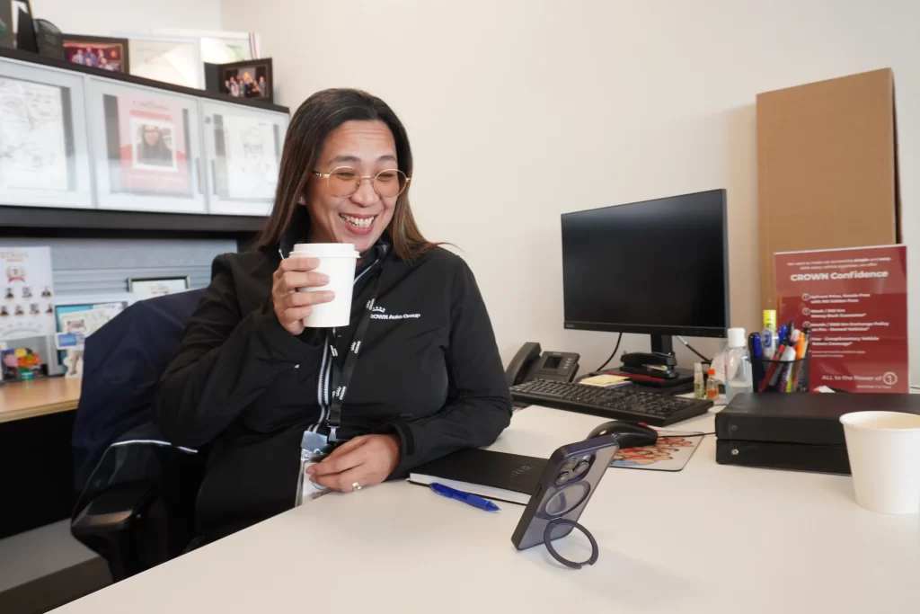 Woman (Carolyn) sipping coffee with her mom on the phone