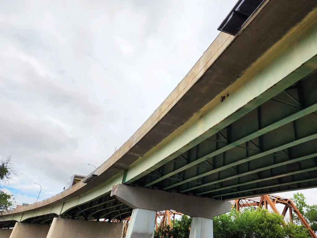The underside of the St. James bridge takes up most of the frame. It's large, and the metal beams are now repaired.
